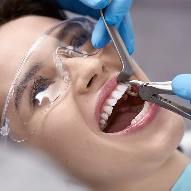 Image of a woman having a tooth pulled