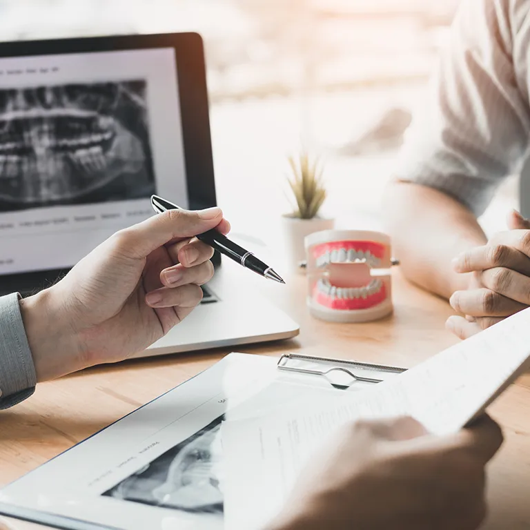 Image of a person holding a pen giving a consultation