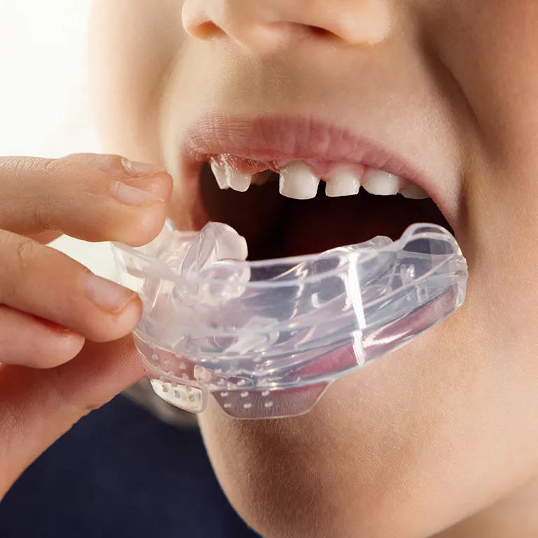 Image of a girl putting a mouth piece in her mouth