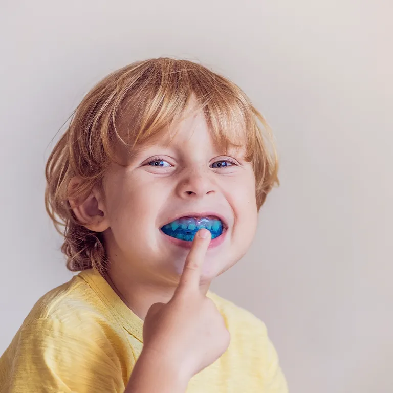 Image of a child putting a myobrace into his mouth