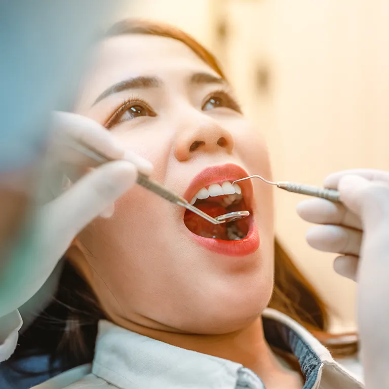 Image of a dentist working in a patients mouth