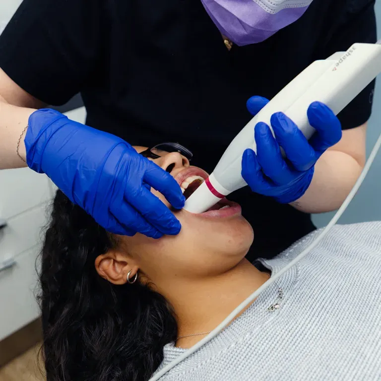 Image of a dentist scanning a womans mouth