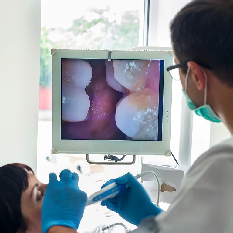 Image of a dentist scanning a persons mouth