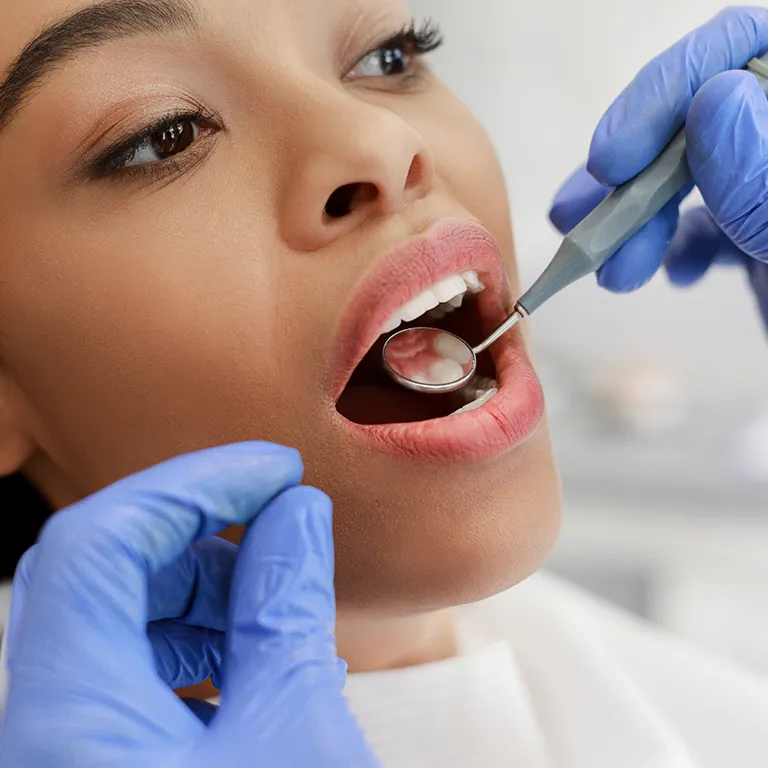 Image of a man having their teeth examined