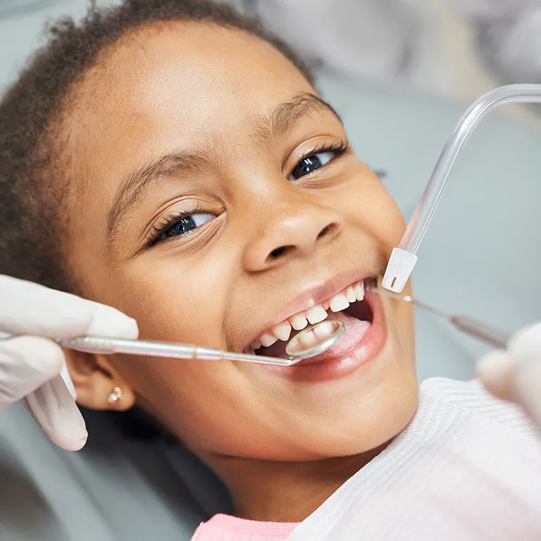 Image of a child having their teeth examined