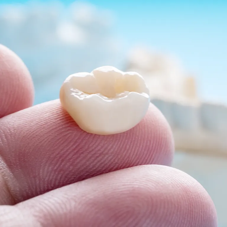 Image of a tooth crown on a finger